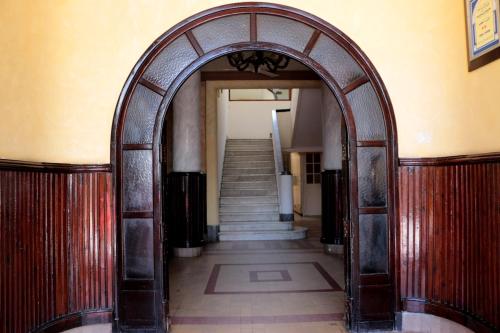 an archway in a hallway with a staircase at Hotel Saint Georges Tunis in Tunis
