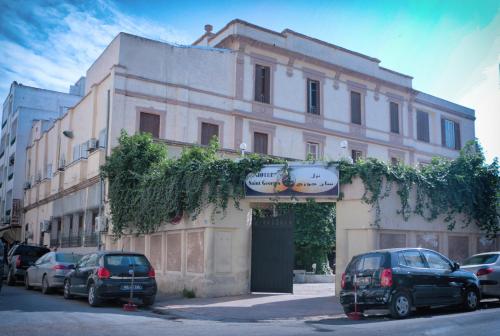 a building with cars parked in front of it at Hotel Saint Georges Tunis in Tunis