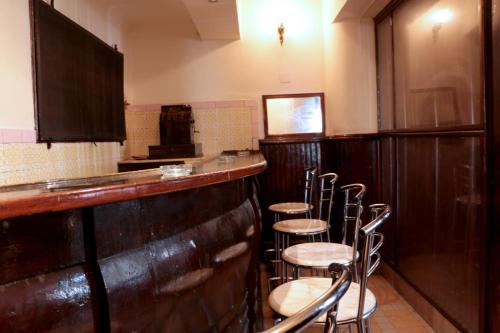 a row of stools at a bar in a restaurant at Hotel Saint Georges Tunis in Tunis