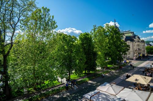 an overhead view of a street with trees and umbrellas at Luxapart V Beautiful Views with Breakfast in Košice