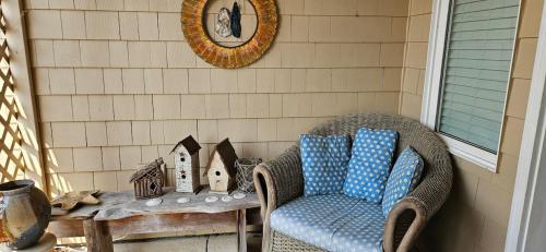 a wicker chair and a table on a porch at BelleVueVilla in Tillamook