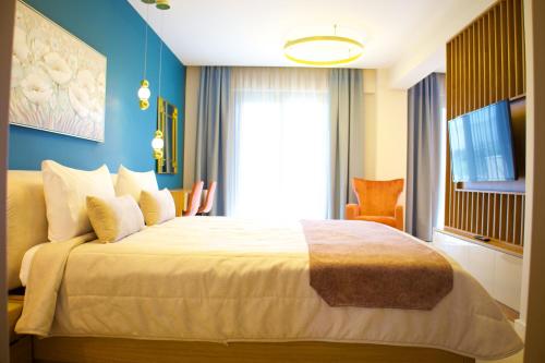a bedroom with a large bed and a window at Sky Boutique Hotel in Perea