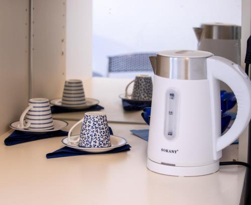 a coffee maker is sitting on a counter with dishes at Sea Front Studio in Fisardo in Fiskardho