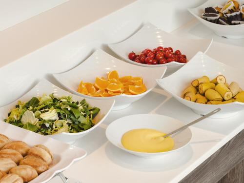 a buffet with bowls of different types of food at Urbanstay Siheung Geobukseom in Siheung