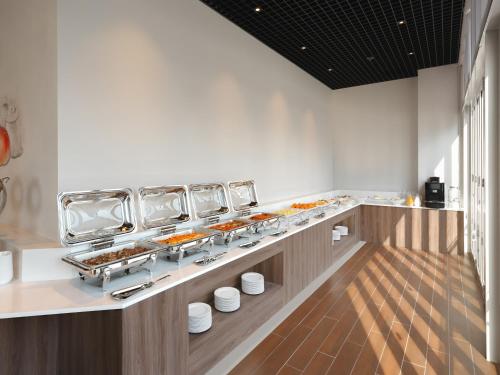 a buffet line with food on display in a restaurant at Urbanstay Siheung Geobukseom in Siheung