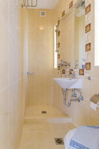 a bathroom with a sink and a shower at Archontariki Luxury suites collection in Lakithra village in Lakithra