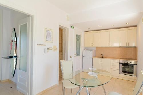 a kitchen with a glass table and chairs at Archontariki Luxury suites collection in Lakithra village in Lakithra