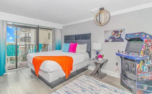 a bedroom with a bed and a desk with a laptop at Ocean Front Beach'n 1BR Premium Condos in Myrtle Beach