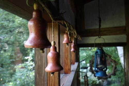 a group of bells hanging on a wall at Lodge Pinokio Backpackers in Nagano