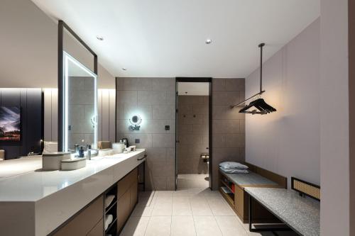 a bathroom with two sinks and a large mirror at Atour Hotel Nantong Development Zone Aeon Mall in Nantong