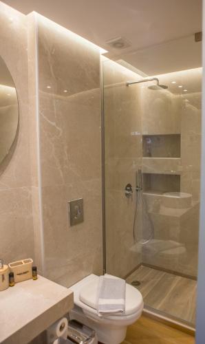 a bathroom with a shower and a toilet at Theo Beach Hotel Apartments in Rethymno Town