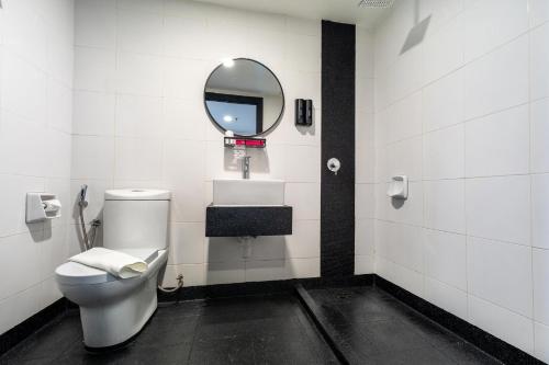 a bathroom with a toilet and a mirror at MagTree Chinatown in Kuala Lumpur