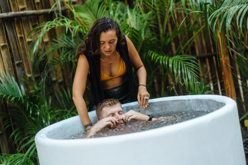 a woman bathing a man in a bath tub at Orion Healing Centre in Srithanu