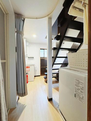 a room with a staircase and a living room at 6 Guests 5min Dobutsuen mae Near Tsutenkaku Shinsekai Direct Namba KIX in Osaka
