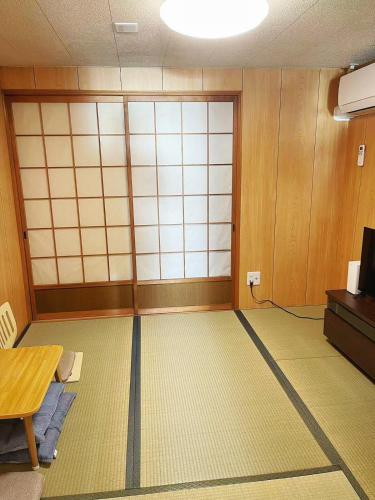 an empty room with a room with a door and a table at 6 Guests 5min Dobutsuen mae Near Tsutenkaku Shinsekai Direct Namba KIX in Osaka