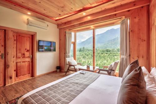 a bedroom with a bed and a large window at Mountain Chalet By Vivaan in Shamshi