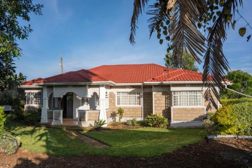 a house with a red roof at Gatundu Slow Life Farm Stay and Hiking in Tea Farms in Kangunyi