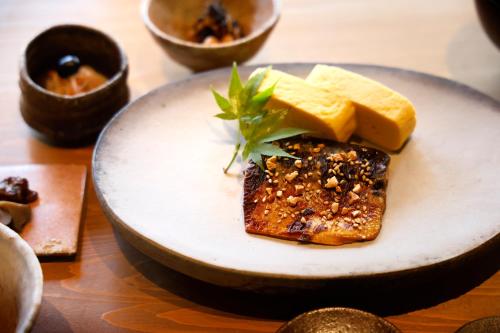 a plate with a piece of food on a table at 豆家mameya in Tamba-sasayama