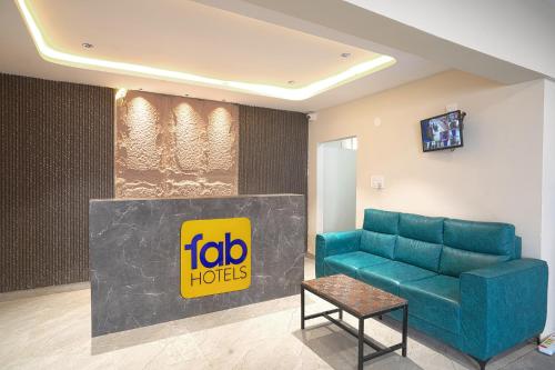 a waiting room with a couch and a table at FabHotel Three Waves- Nr LB Nagar Metro Station in Surūrnagar