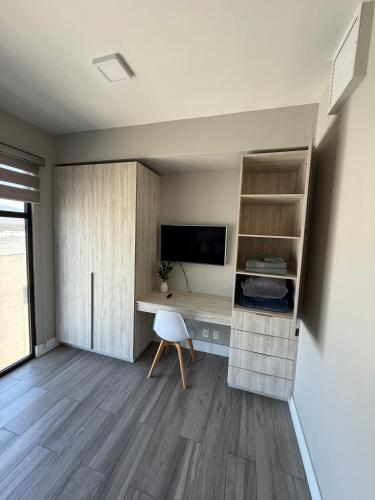 a room with a desk and a computer in it at Carlos and Jocelin's department in Tijuana