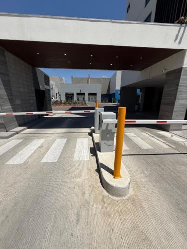 a parking meter in the middle of a parking lot at Carlos and Jocelin's department in Tijuana