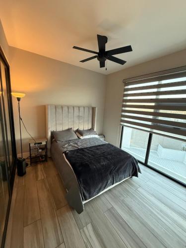 a bedroom with a bed and a ceiling fan at Carlos and Jocelin's department in Tijuana