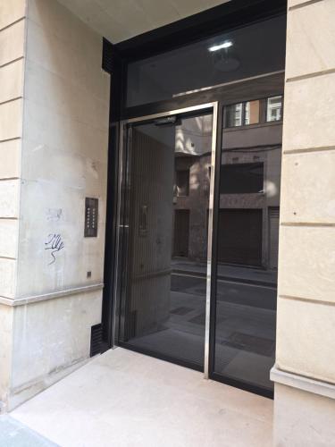 an entrance to a building with a glass door at La Buhardilla de la Escalerona - 2 Hab - VUT-4354-AS in Gijón