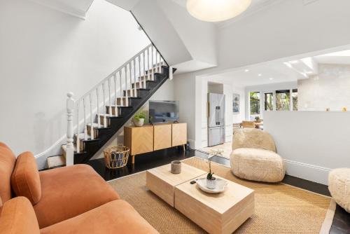 a living room with a couch and a table at 5BR Paddington Home w Private Parking and Studio in Sydney