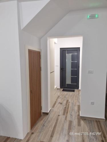 an empty room with a door and a wooden floor at BOK Holiday VILLAGE Kolasin in Kolašin