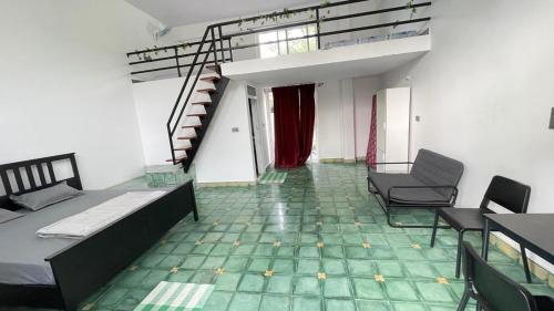 a room with a bed and chairs and a staircase at Aari Farms- The Exotic Celebrations in Bengaluru