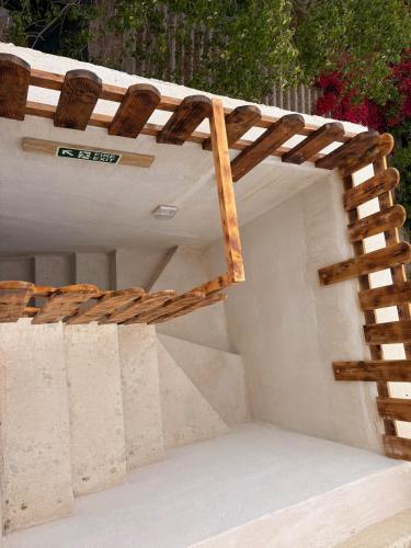 a building with a ladder on the side of it at Traditional Maltese Family Townhouse - Cospicua in Cospicua