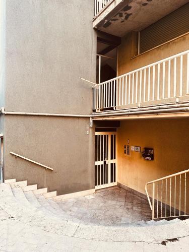 a building with stairs on the side of it at Elegance Rooms Cefalù in Cefalù