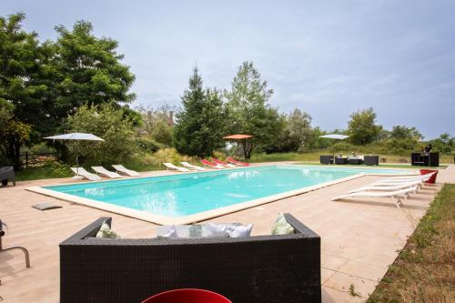 a swimming pool with lounge chairs at CHATEAU du PERRAY in Saint-Mars-du-Désert