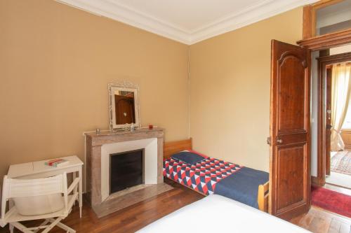 a room with a fireplace and a bed in it at CHATEAU du PERRAY in Saint-Mars-du-Désert