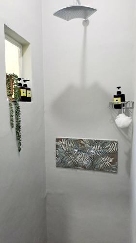 a white room with a wall with a painting on it at Happy'Nest at Garden Route in Riversdale