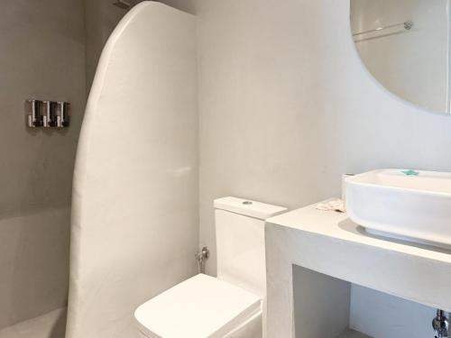 a bathroom with a sink and a toilet and a mirror at Pallas Seaside 1 in Athens