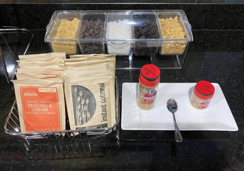 a table topped with containers of food and a spoon at Quality Inn Kenly I-95 in Kenly