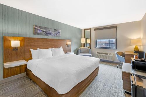 a hotel room with a large bed and a television at Sleep Inn Oakbrook Terrace - Chicago in Oakbrook Terrace