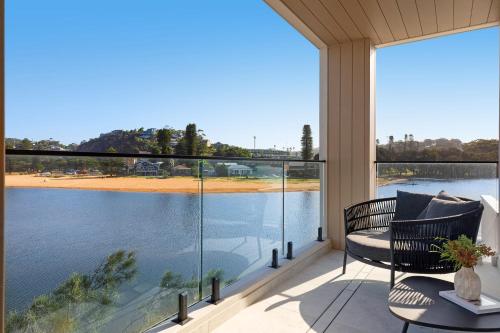 a balcony with a view of a body of water at Maggie's by Coast Hosting in North Avoca