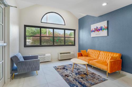 a living room with an orange couch and a chair at Quality Inn & Suites in Knoxville