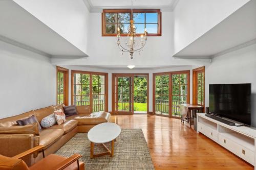 a living room with a couch and a tv at The Manor by Coast Hosting in Holgate