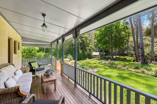 an outdoor deck with a couch and chairs and a yard at The Manor by Coast Hosting in Holgate