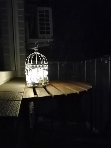 a bird cage sitting on a table in a dark room at Few Steps to the Bay in Jūrmala