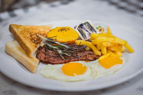 a plate of food with eggs and french fries at ATKV Natalia in Kingsburgh