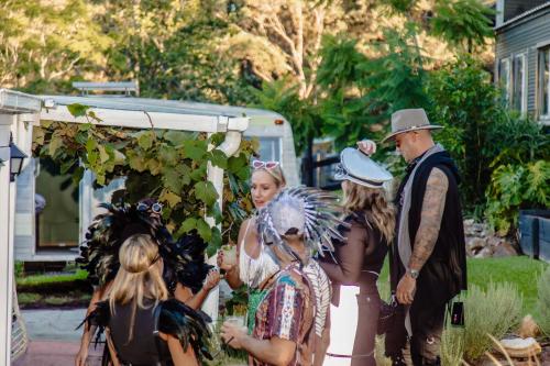 a group of people in costumes standing next to a tent at Cosy Family Farm Stay - Daily Animal Feeding in Wamberal