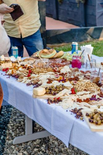 a table with many different types of food on it at Cosy Family Farm Stay - Daily Animal Feeding in Wamberal