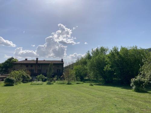 a house in a field with a large yard at Casa del Grivò - Alloggio Luna in Canal di Grivo