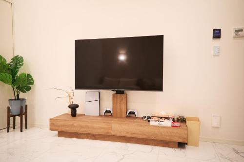 a flat screen tv on a wall in a living room at IoTele南青山 in Tokyo