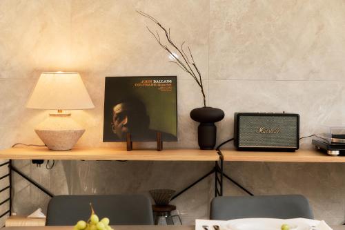 a shelf with a laptop and a lamp on it at IoTele南青山 in Tokyo