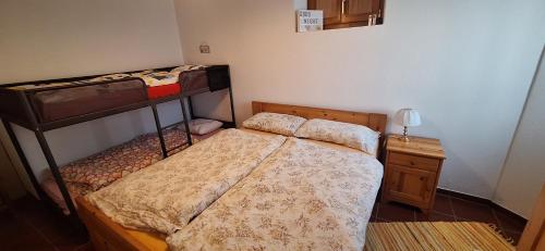 a bedroom with two bunk beds and a night stand at Il Rustico ticinese di Brè in Brè sopra Lugano